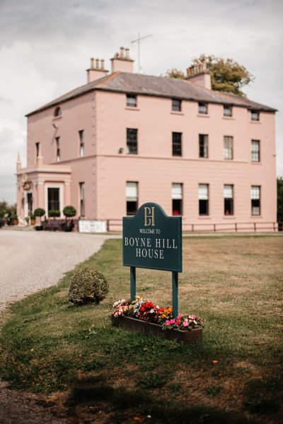 Exterior salmon coloured building wedding venue Boyne Hill house sign