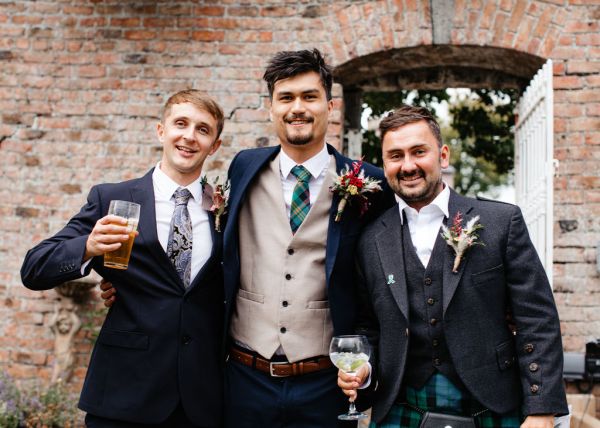 Groom and groomsmen drinking beer