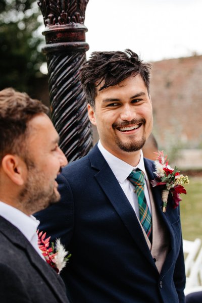 Groom and groomsmen smile and laugh