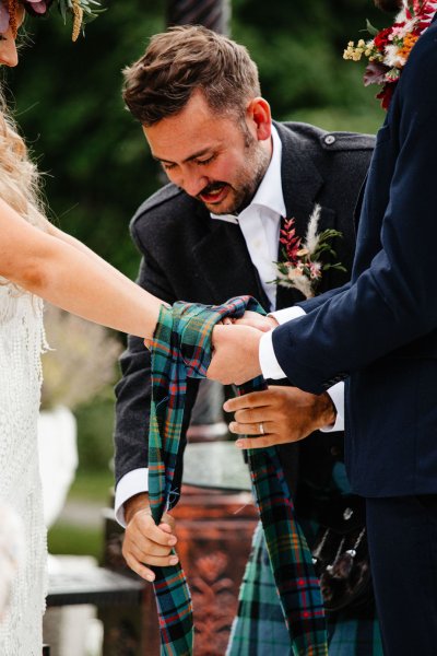 Bride and groom ribbon hands