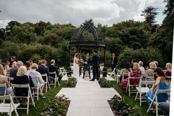 Bride and groom at alter with officiant guests