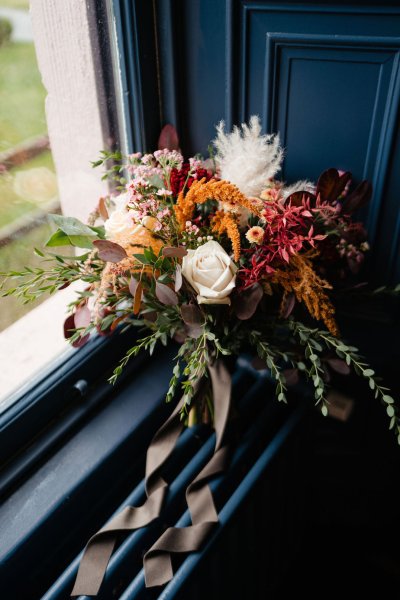 Up close flowers/white roses at window