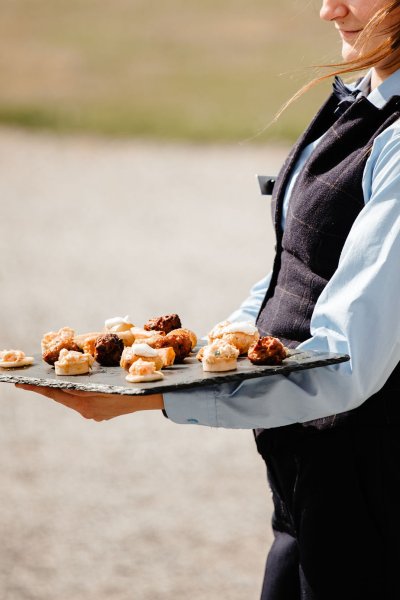 Waiter serves finger food