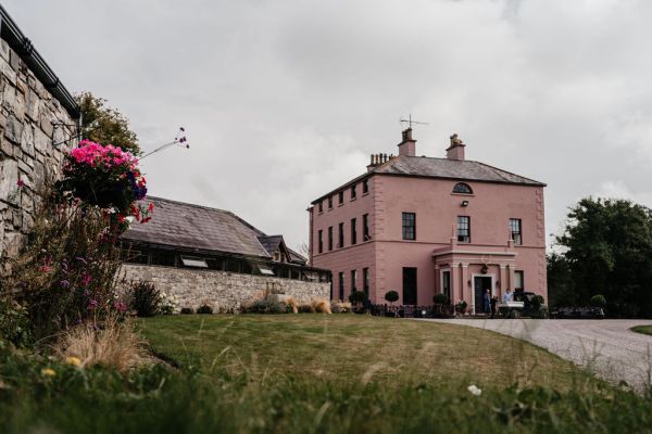 Exterior salmon coloured building wedding venue Boyne Hill house sign