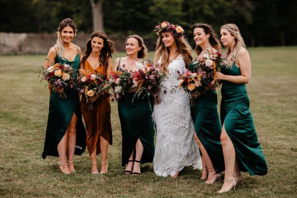 Bride and bridesmaids holding bouquet of flowers