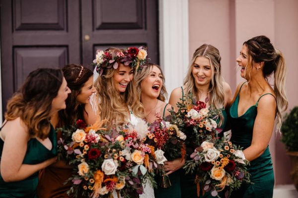 Bride and bridesmaids flowers in hands entrance to wedding venue