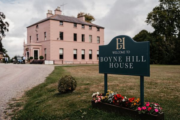 Exterior salmon coloured building wedding venue Boyne Hill house sign