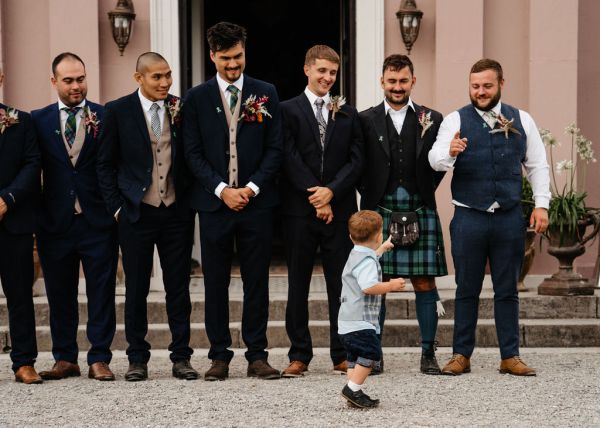 groom and groomsmen exterior wedding venue little boy son