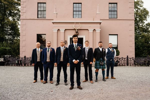 groom and groomsmen exterior wedding venue