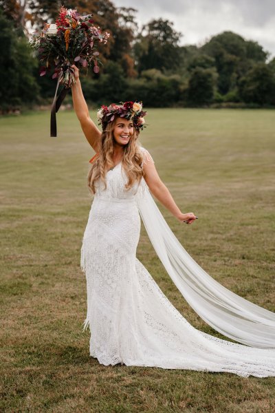 bride with roses flowers in her hair on grass dress detail veil