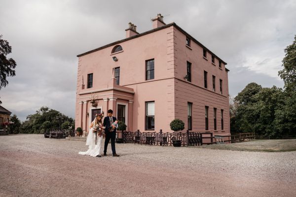 Bride and groom exterior wedding venue and little baby