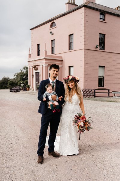 Bride and groom exterior wedding venue and little baby