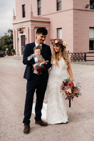 Bride and groom exterior wedding venue and little baby