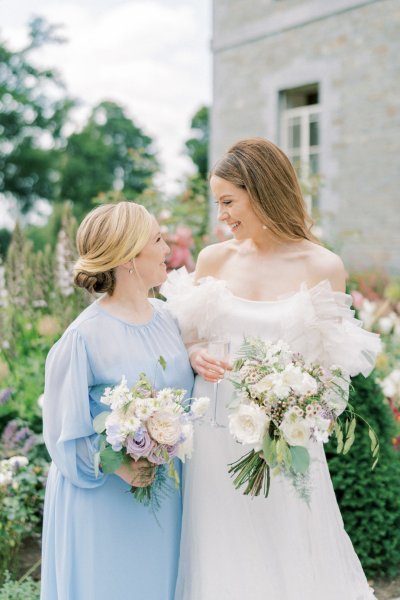 Bride and bridesmaid holding flowers