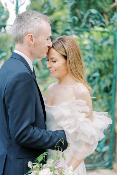 Groom hugging bride in garden