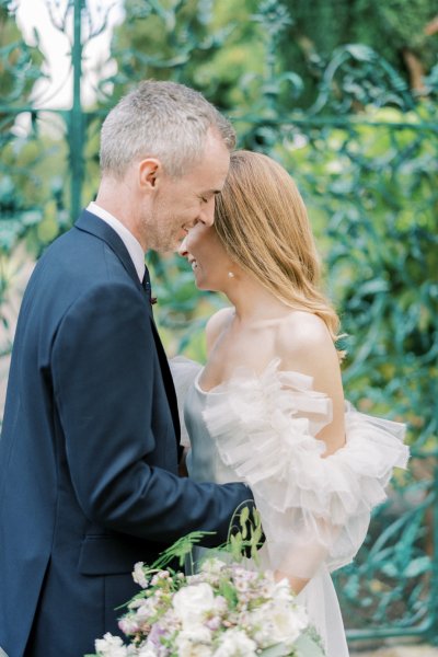 Groom hugging bride in garden