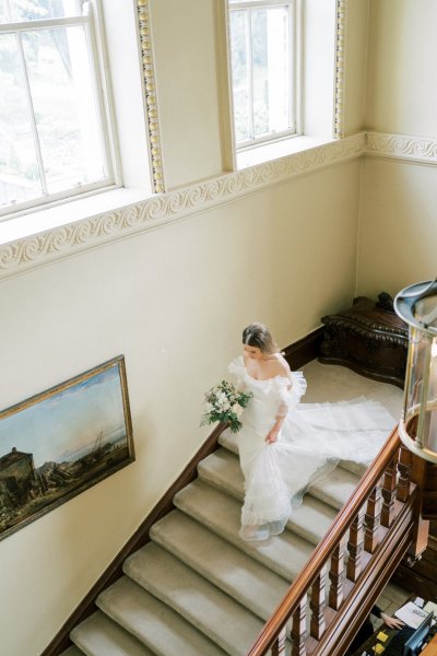 Bride walks down staircase stairs