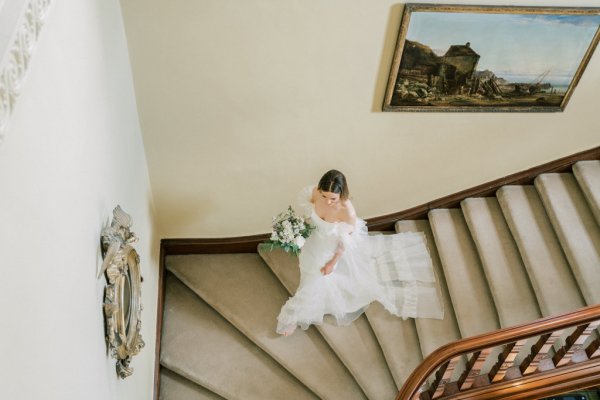 Bride walks down staircase stairs