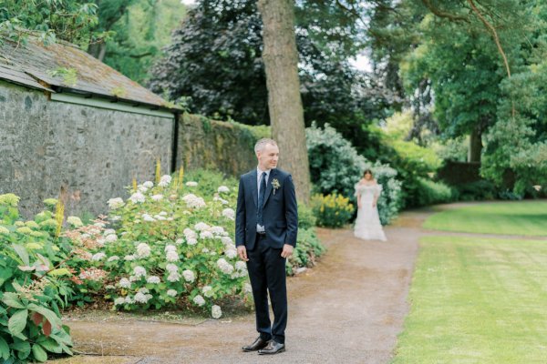 Groom waiting for bride in garden