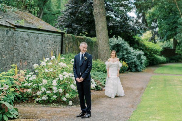 Groom waiting for bride in garden