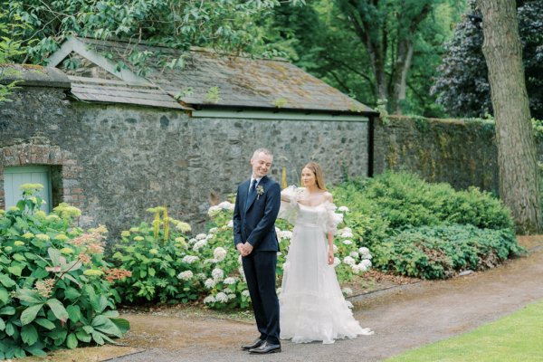 Groom waiting for bride in garden