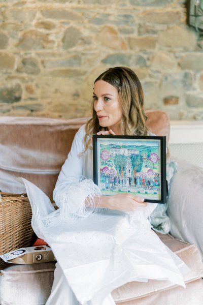 Bride holds frame present gift