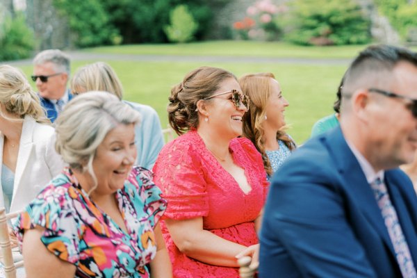 Happy guests in audience waiting for bride