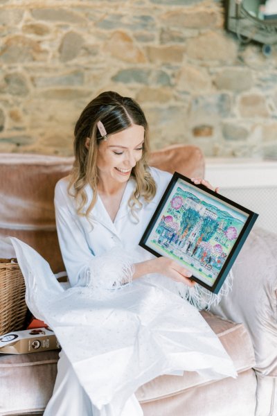 Bride holds frame present gift