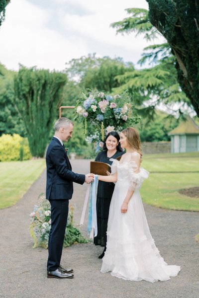 Bride groom ribbon and officiant