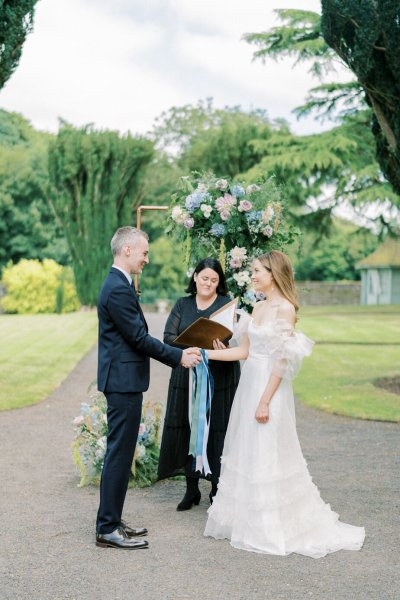 Bride groom ribbon and officiant