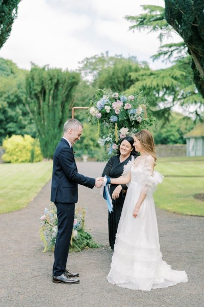 Bride groom ribbon and officiant