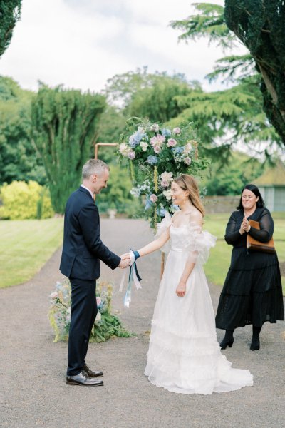 Bride groom ribbon and officiant