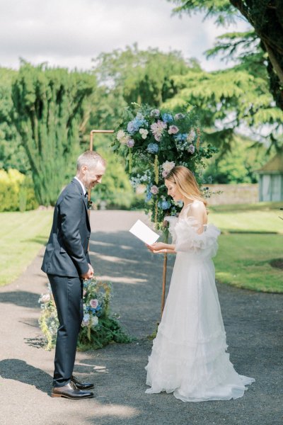 Bride and groom reading vows during ceremony