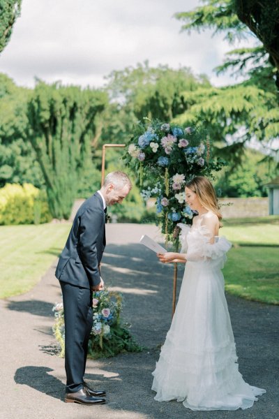 Bride and groom reading vows during ceremony