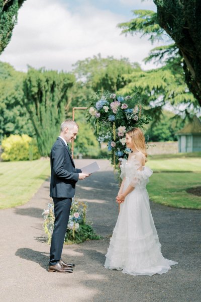 Bride and groom reading vows during ceremony