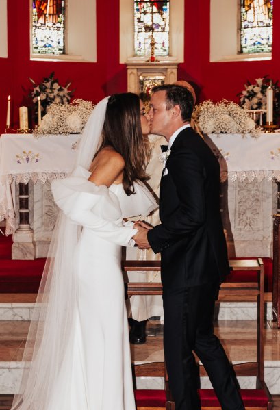 Bride and groom kiss kissing