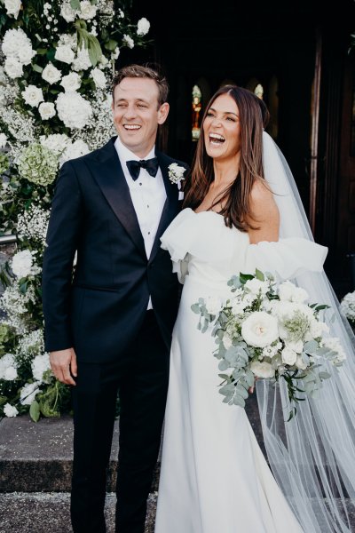 Bride and groom just wed exterior church laughing