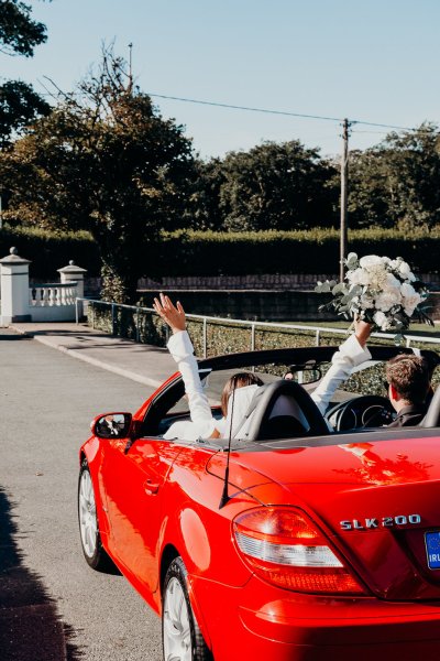 Just wed red wedding car veil hands in the air