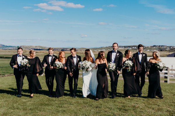 Bride groomsmen flowers bridesmaids wearing black