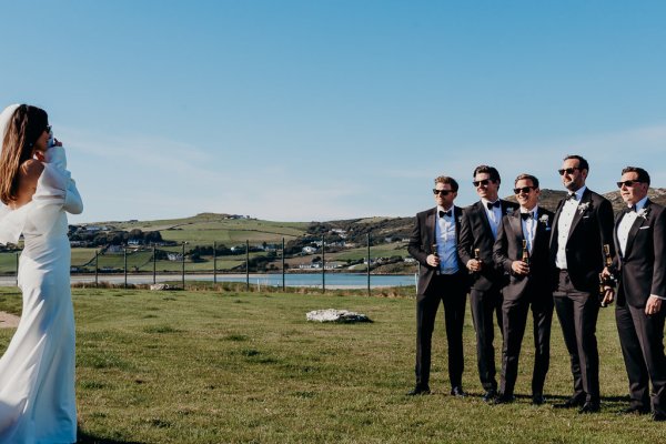 Bride approaches groom and groomsmen