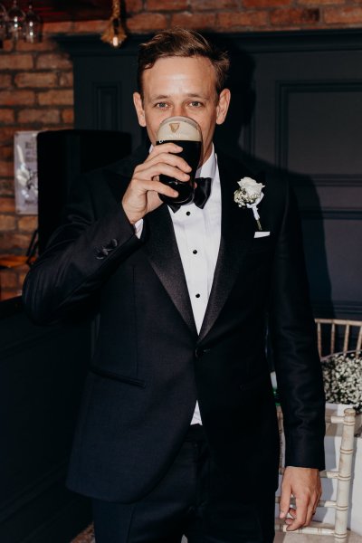 Groom drinking Guinness