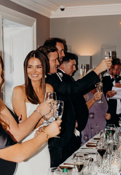 Bride cheers and guests groom