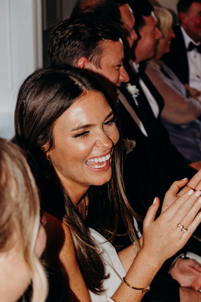 Bride laughs and smiles at the table