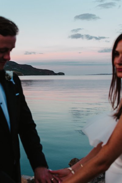 Scenic background lake ocean view with bride and groom