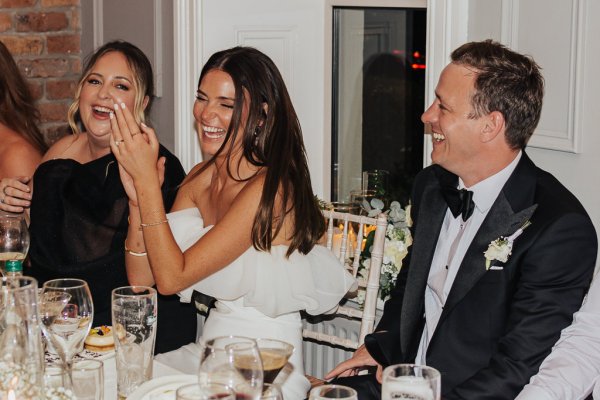 Bride clapping at table