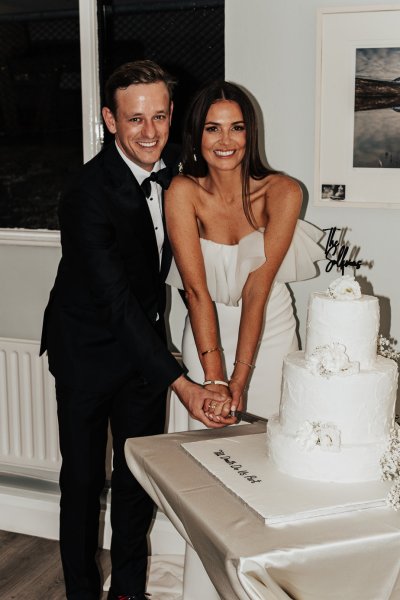 Bride and groom cut the cake together