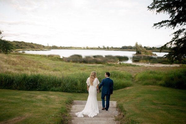 Bride and groom exterior forest sand beach setting with lake