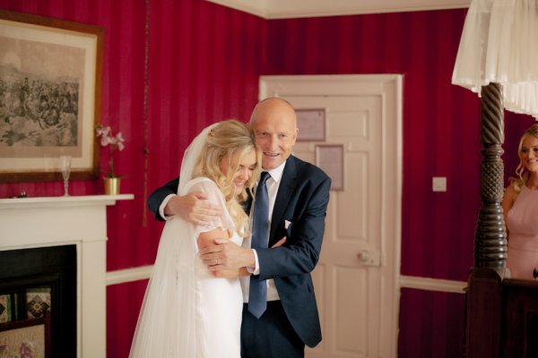 father of the bride hugging embracing