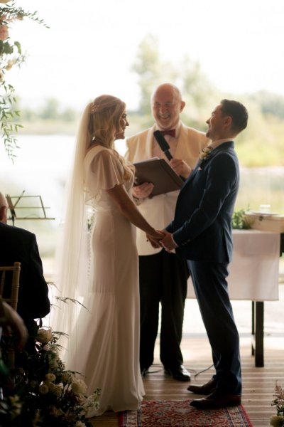 Bride groom and officiant church setting