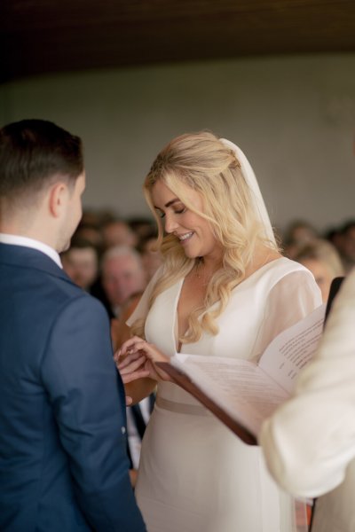 Groom puts wedding ring on finger I do's